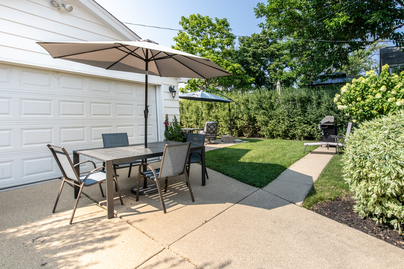 900 Rowe Avenue Park Ridge, IL 60068 - Photo 16 of 32 a view of a patio with a table and chairs under an umbrella