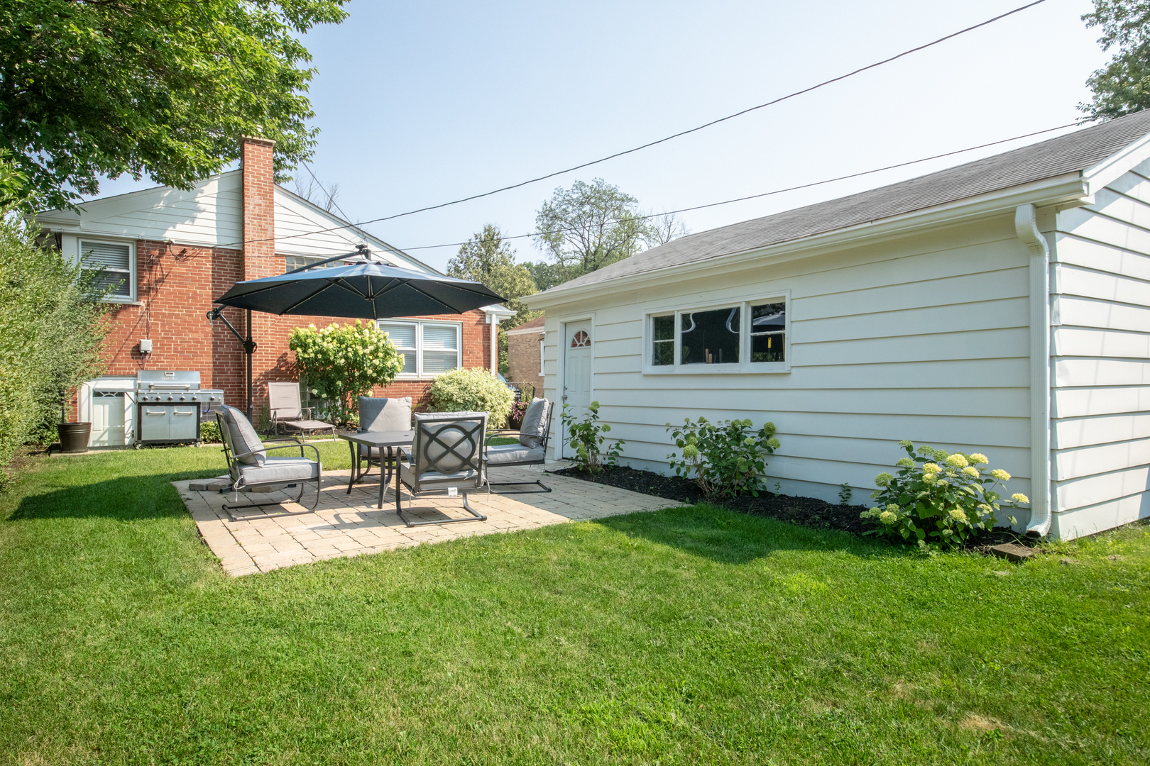 900 Rowe Avenue Park Ridge, IL 60068 - Photo 19 of 32 a view of a patio with table and chairs and potted plants