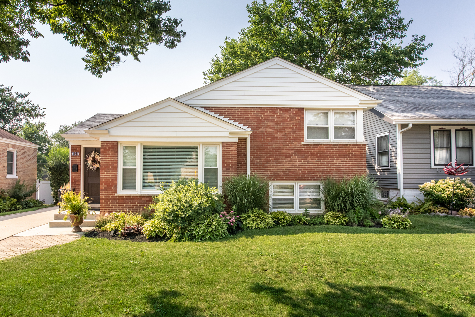 900 Rowe Avenue Park Ridge, IL 60068 - Photo 2 of 32 a front view of a house with a yard and porch