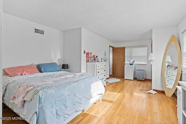 a bed room with a bed and a flat tv screen