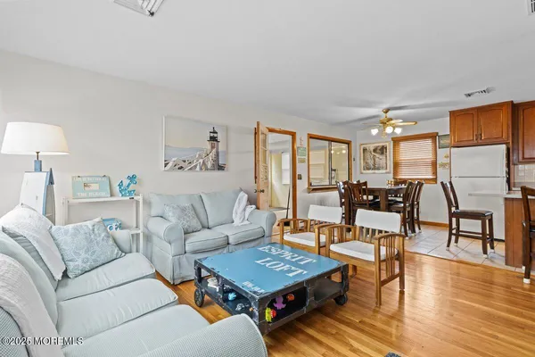 a living room with furniture a wooden floor and a table