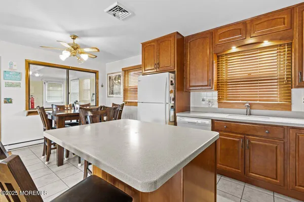 a kitchen with a table chairs and chandelier