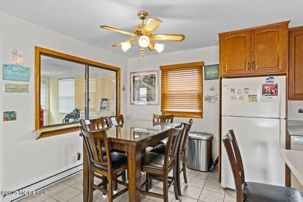 a view of a dining room with furniture and a chandelier