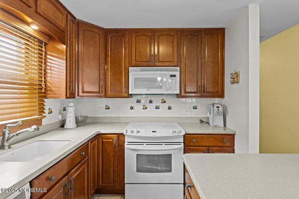 a kitchen with stainless steel appliances a stove a sink and a microwave