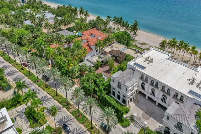 an aerial view of residential house with outdoor space and trees all around