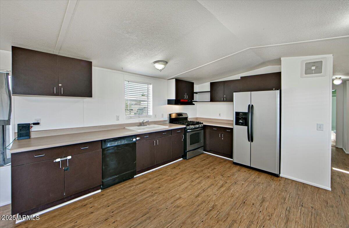15339 South Rolling Ridge Drive Mayer, AZ 86333 - Photo 8 of 20 a kitchen with a refrigerator and a stove top oven