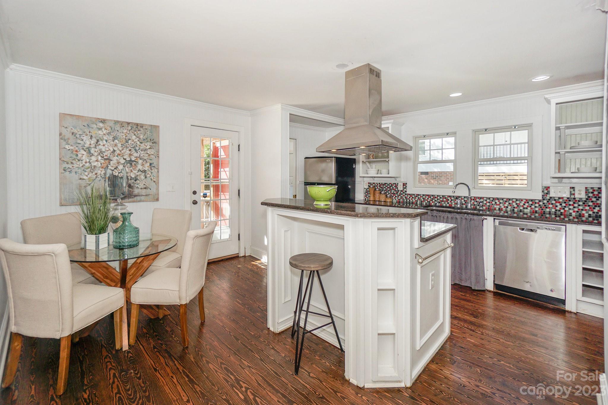 303 Houston Street Davidson, NC 28036 - Photo 8 of 29 a kitchen with stainless steel appliances granite countertop a kitchen island hardwood floor sink stove and wooden cabinets