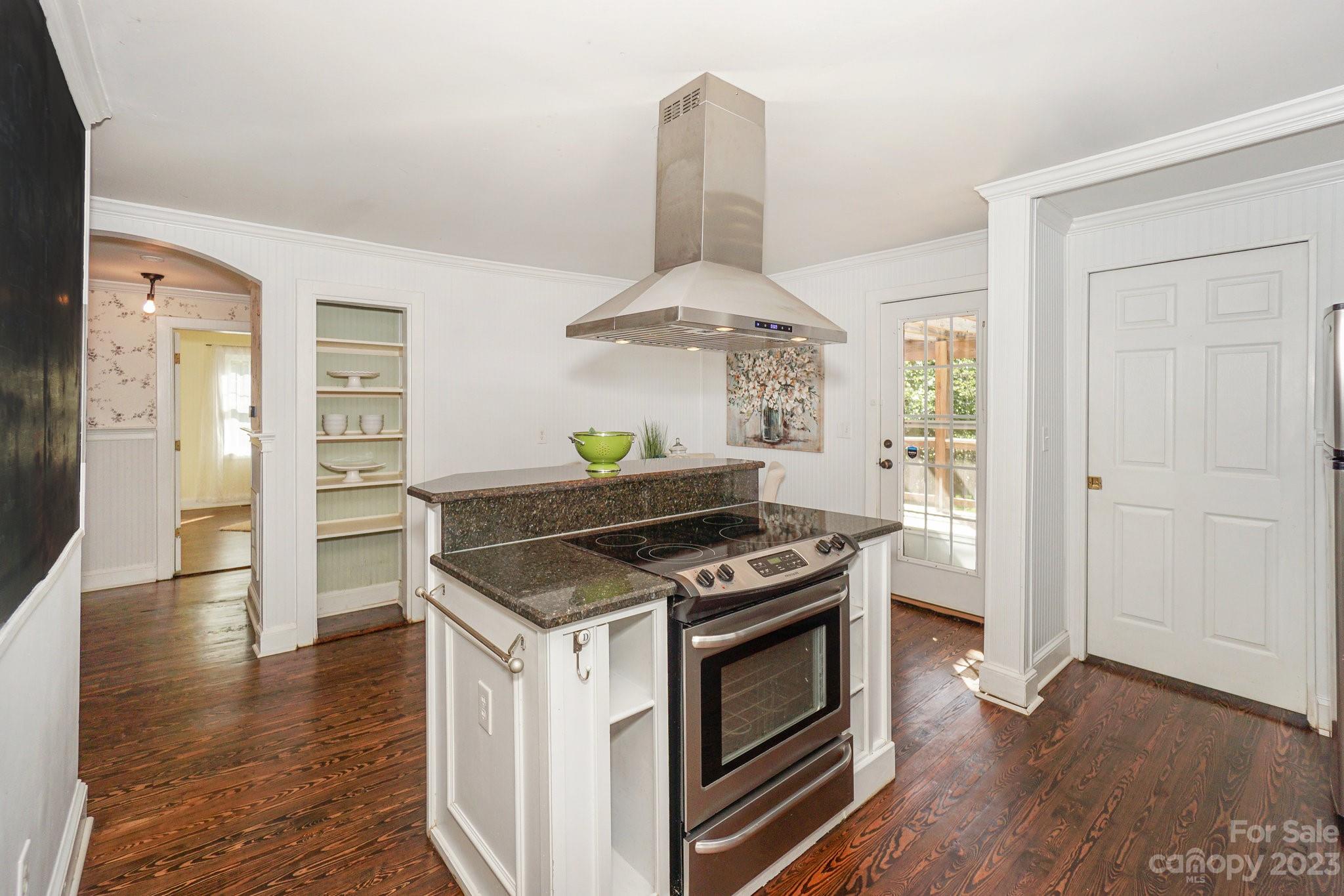 303 Houston Street Davidson, NC 28036 - Photo 9 of 29 a kitchen with a stove and wooden floor