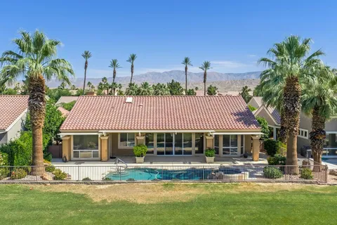 a front view of house with yard swimming pool and outdoor seating