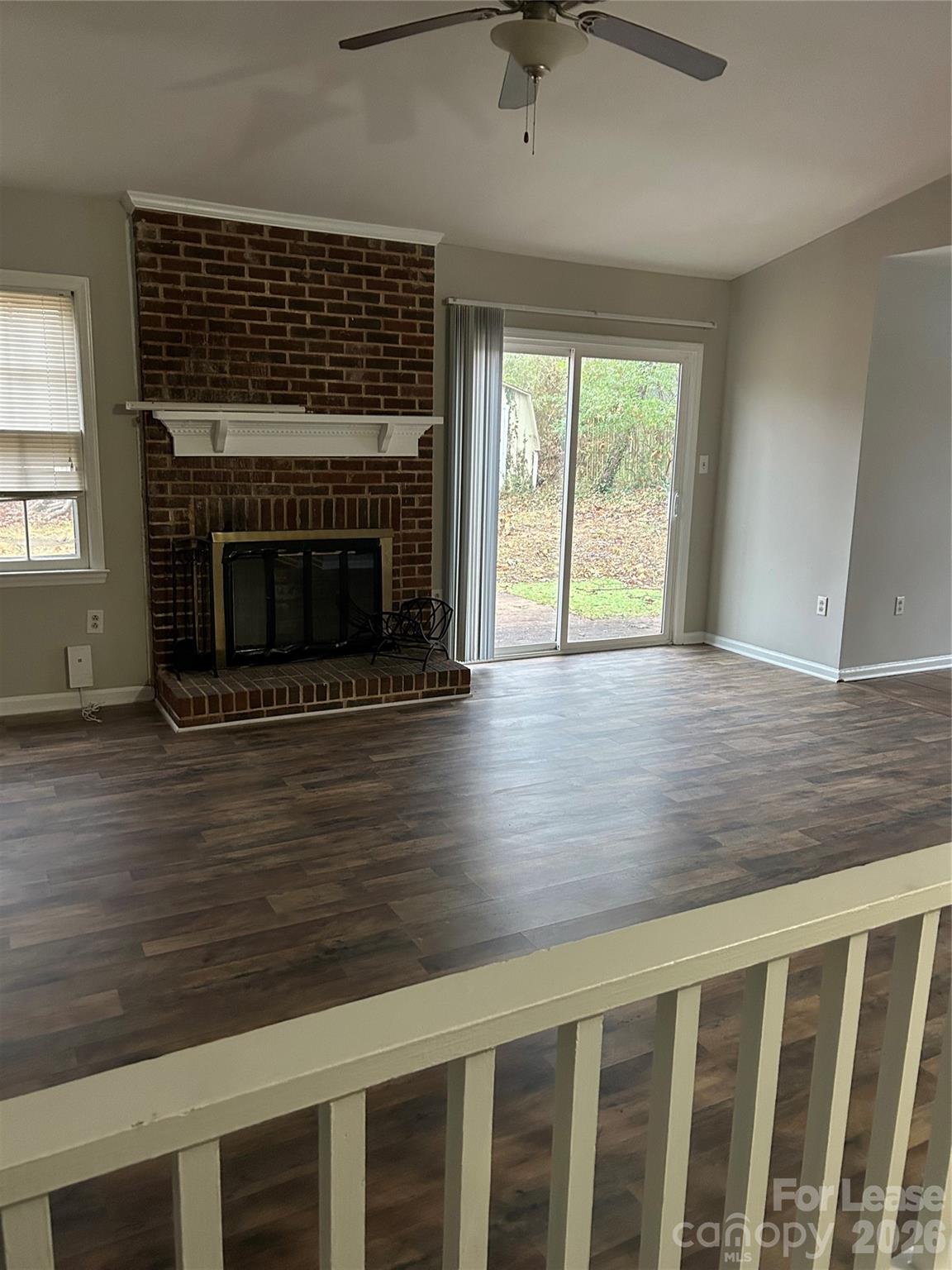 506 Fence Post Lane Matthews, NC 28105 - Photo 2 of 9 a living room with wooden floor a fireplace and a window