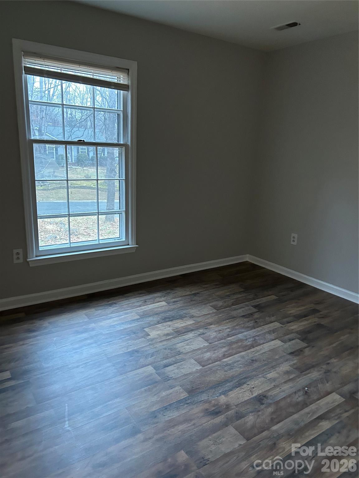 506 Fence Post Lane Matthews, NC 28105 - Photo 6 of 9 an empty room with wooden floor and windows