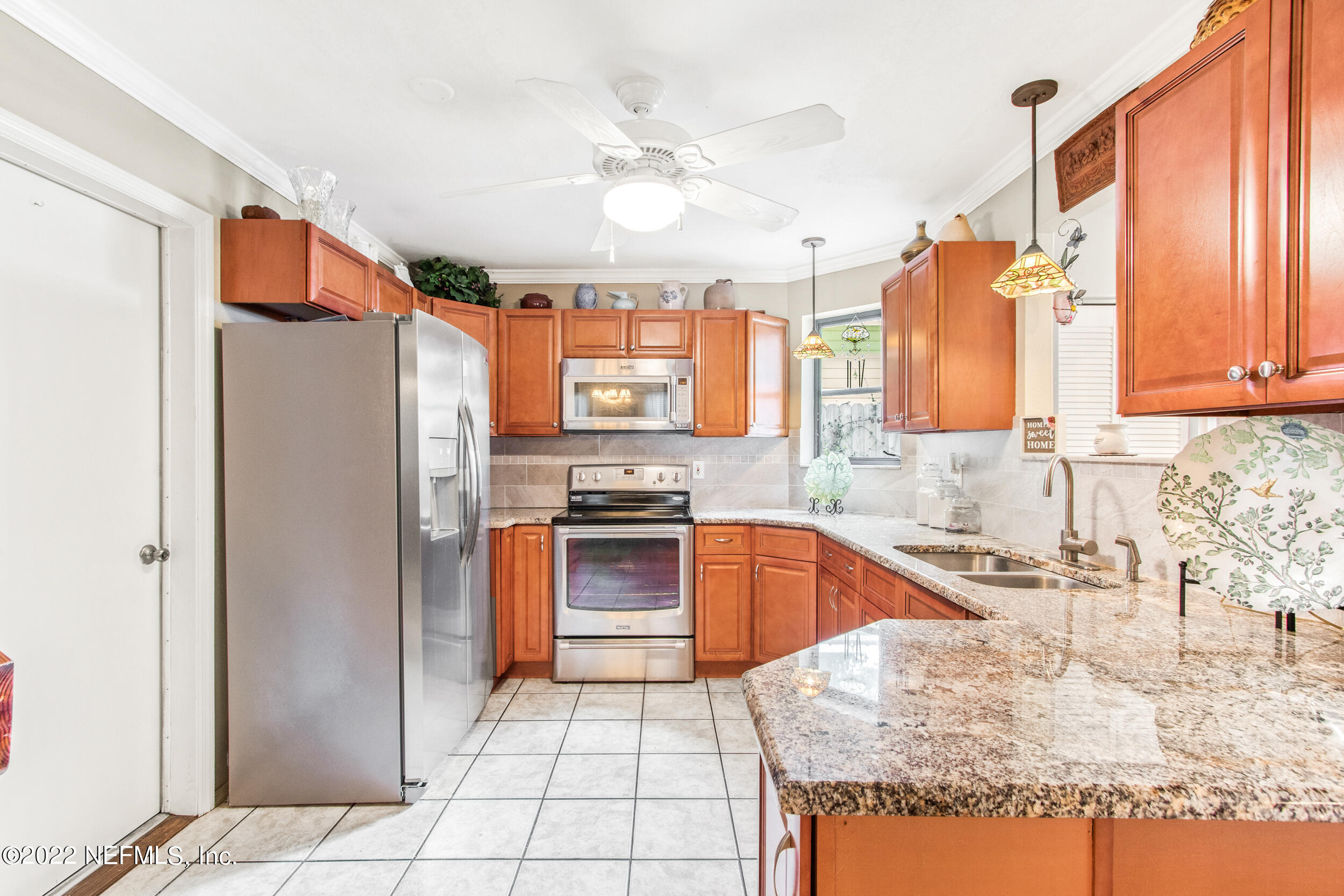 19 Madeore Street St. Augustine, FL 32084 - Photo 12 of 28 a kitchen with stainless steel appliances granite countertop a refrigerator and a sink