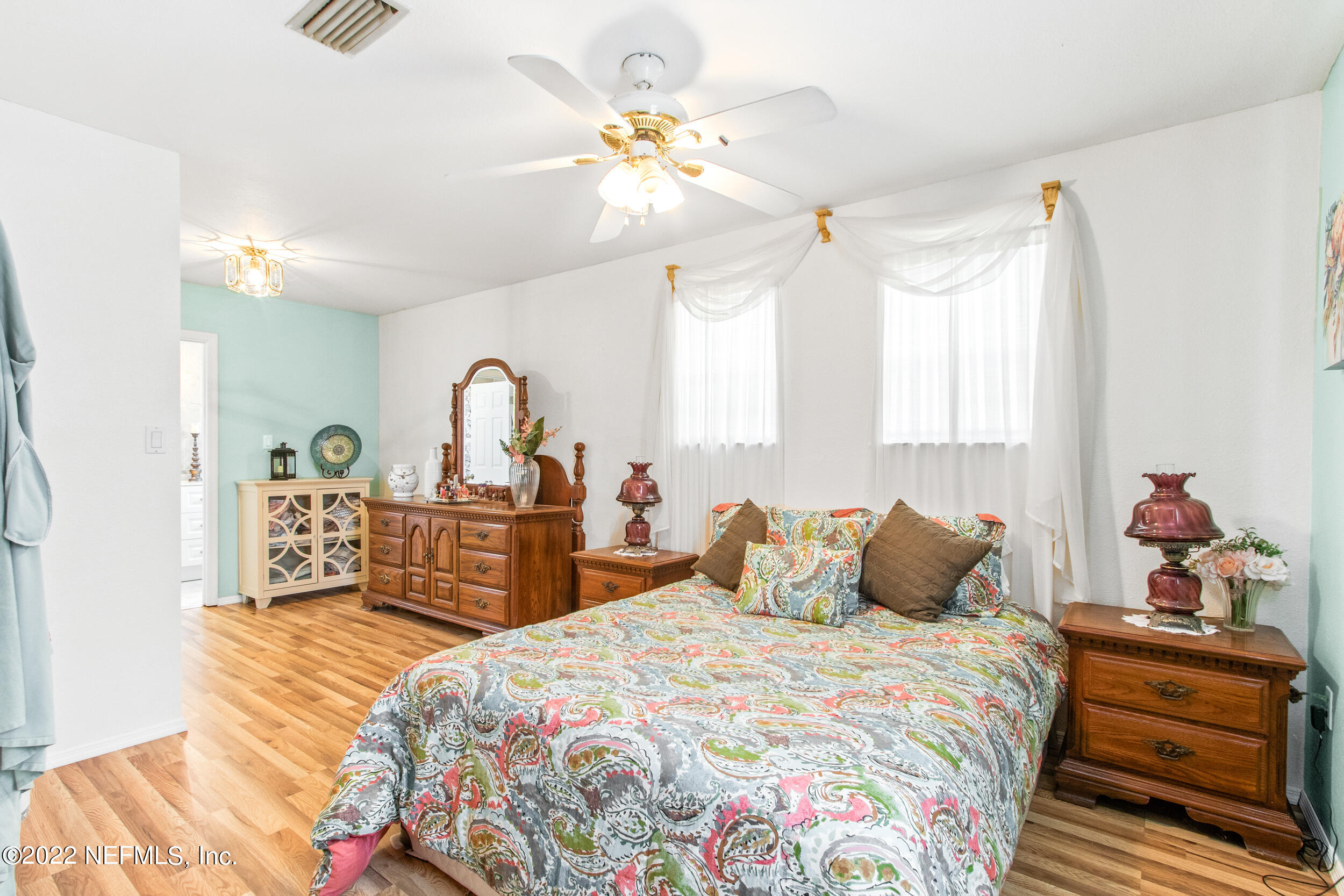 19 Madeore Street St. Augustine, FL 32084 - Photo 19 of 28 a bedroom with a bed and a chandelier