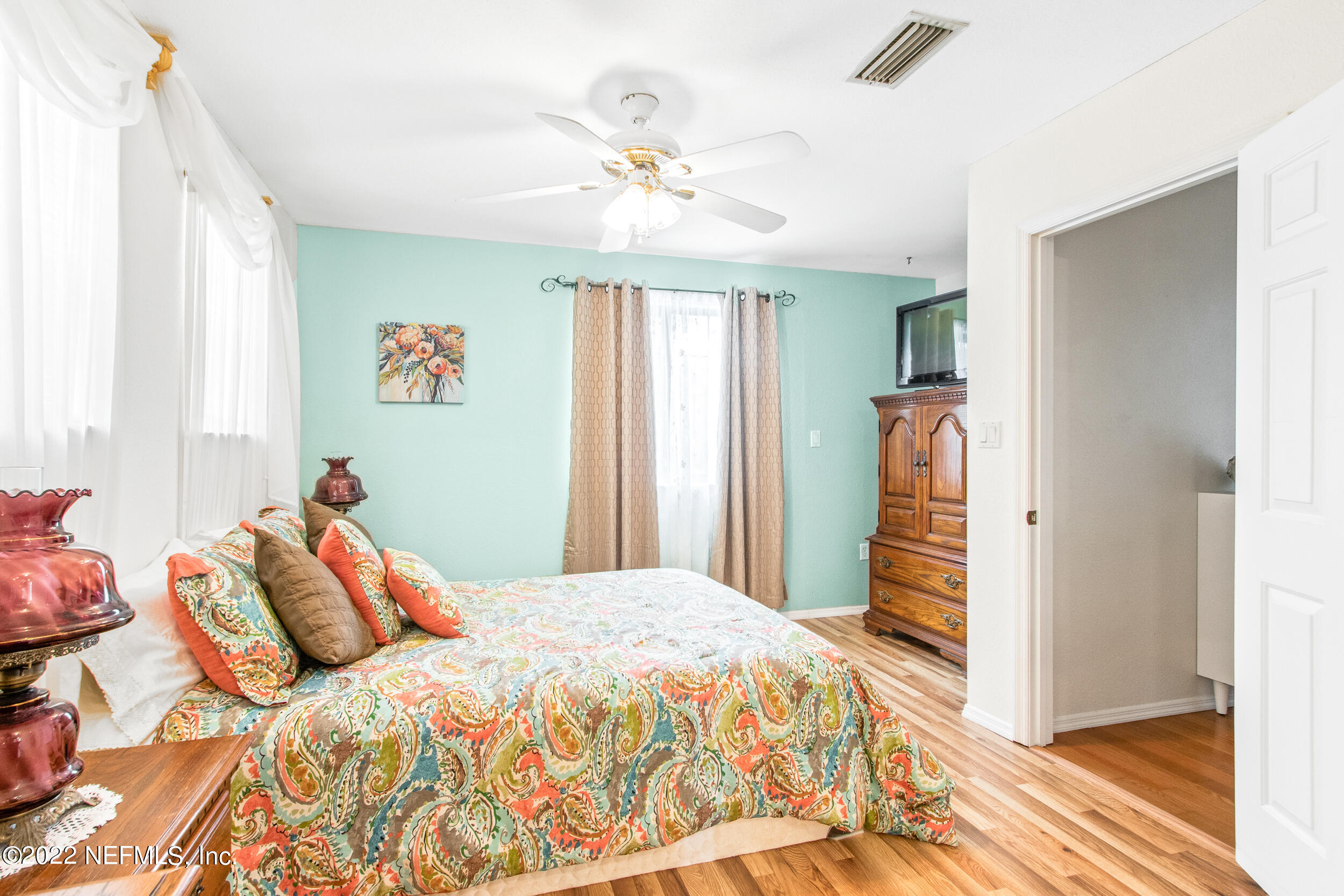 19 Madeore Street St. Augustine, FL 32084 - Photo 20 of 28 a bedroom with a bed and a chandelier