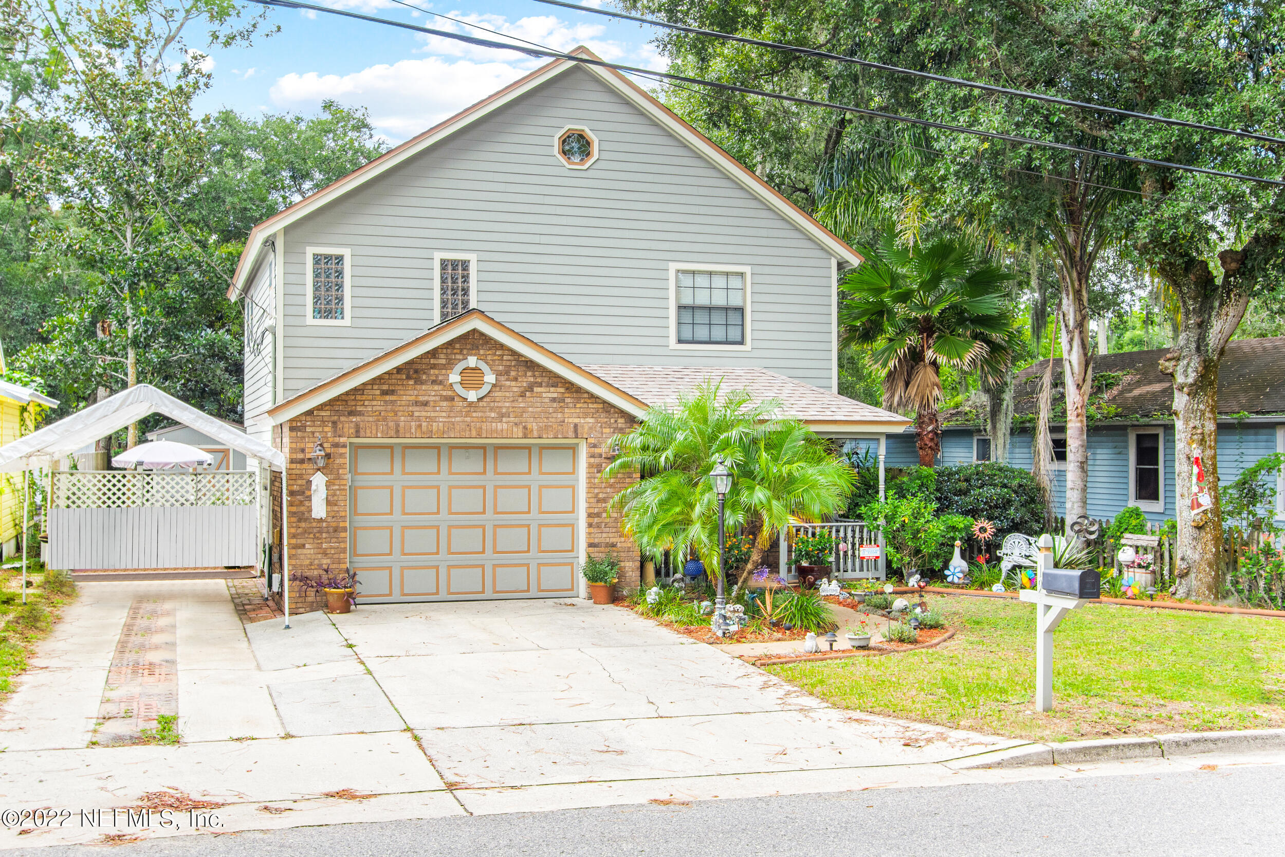 19 Madeore Street St. Augustine, FL 32084 - Photo 2 of 28 a view of a house with a yard plants and large tree
