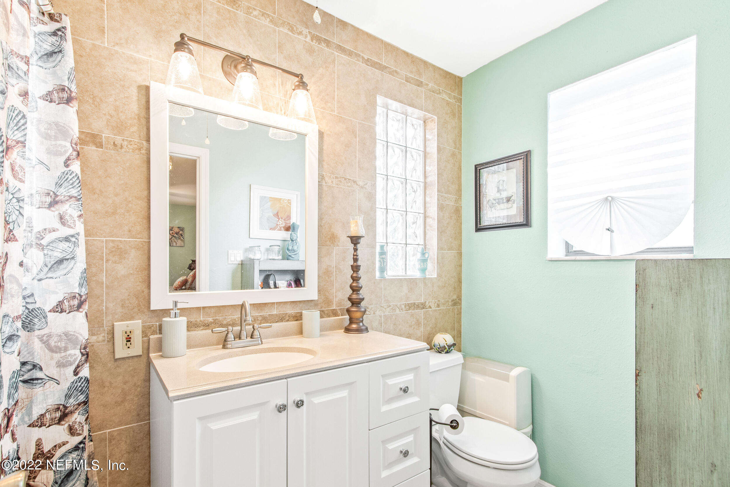 19 Madeore Street St. Augustine, FL 32084 - Photo 22 of 28 a bathroom with a sink a toilet and a mirror