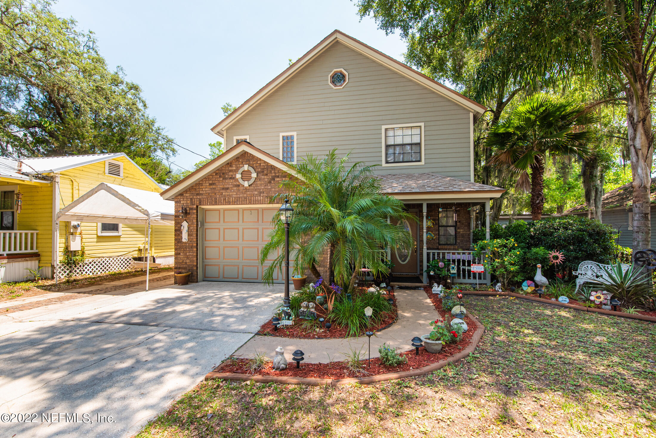 19 Madeore Street St. Augustine, FL 32084 - Photo 28 of 28 a front view of a house with a yard and potted plants