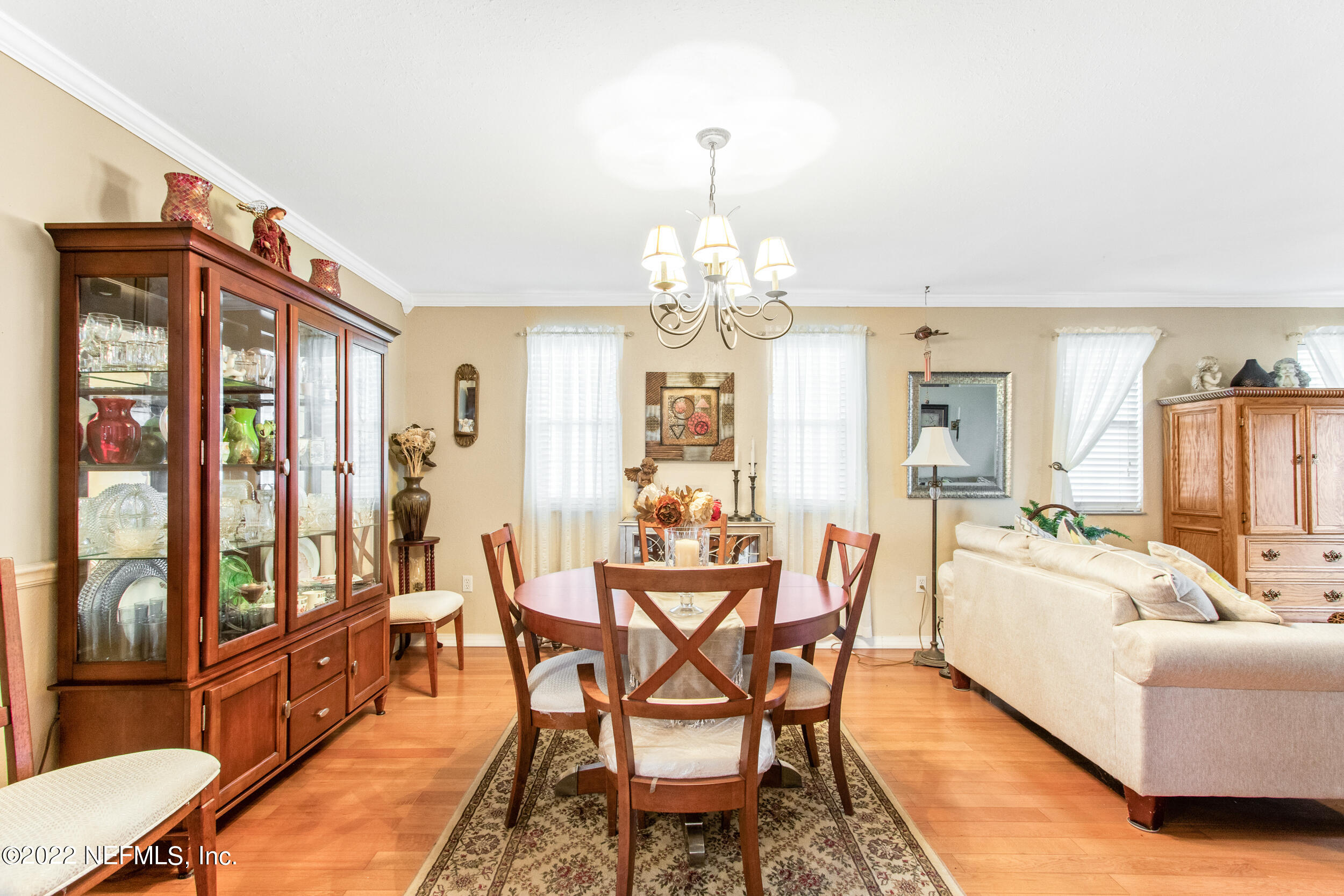 19 Madeore Street St. Augustine, FL 32084 - Photo 10 of 28 a dining room with furniture a chandelier and wooden floor