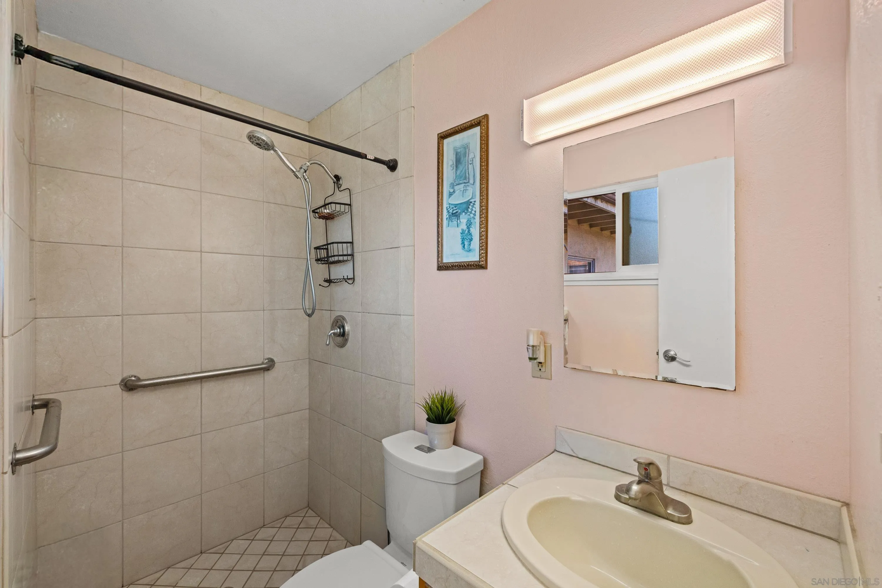 284 Osage Drive Salinas, CA 93906 - Photo 19 of 24 a bathroom with a sink mirror toilet and shower