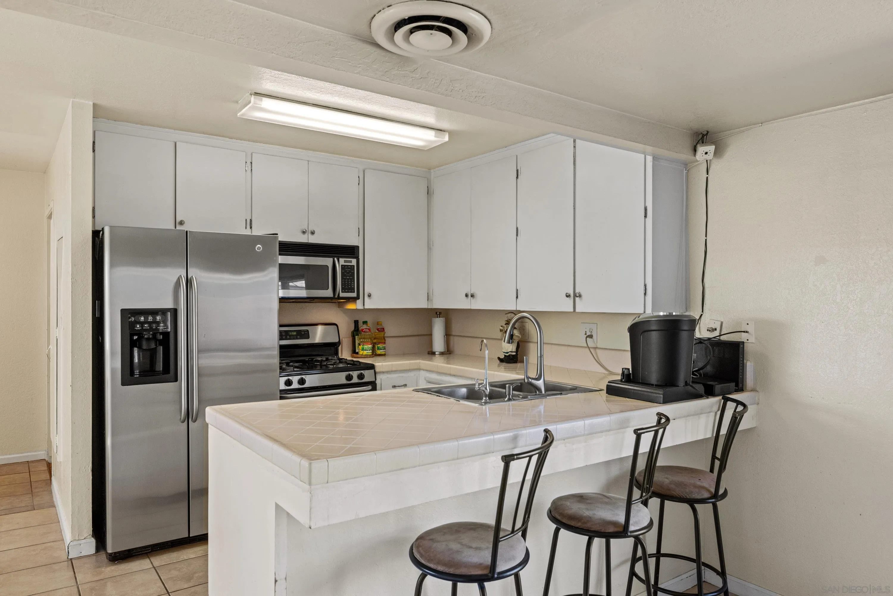 284 Osage Drive Salinas, CA 93906 - Photo 6 of 24 a kitchen with a refrigerator a stove a sink and a refrigerator