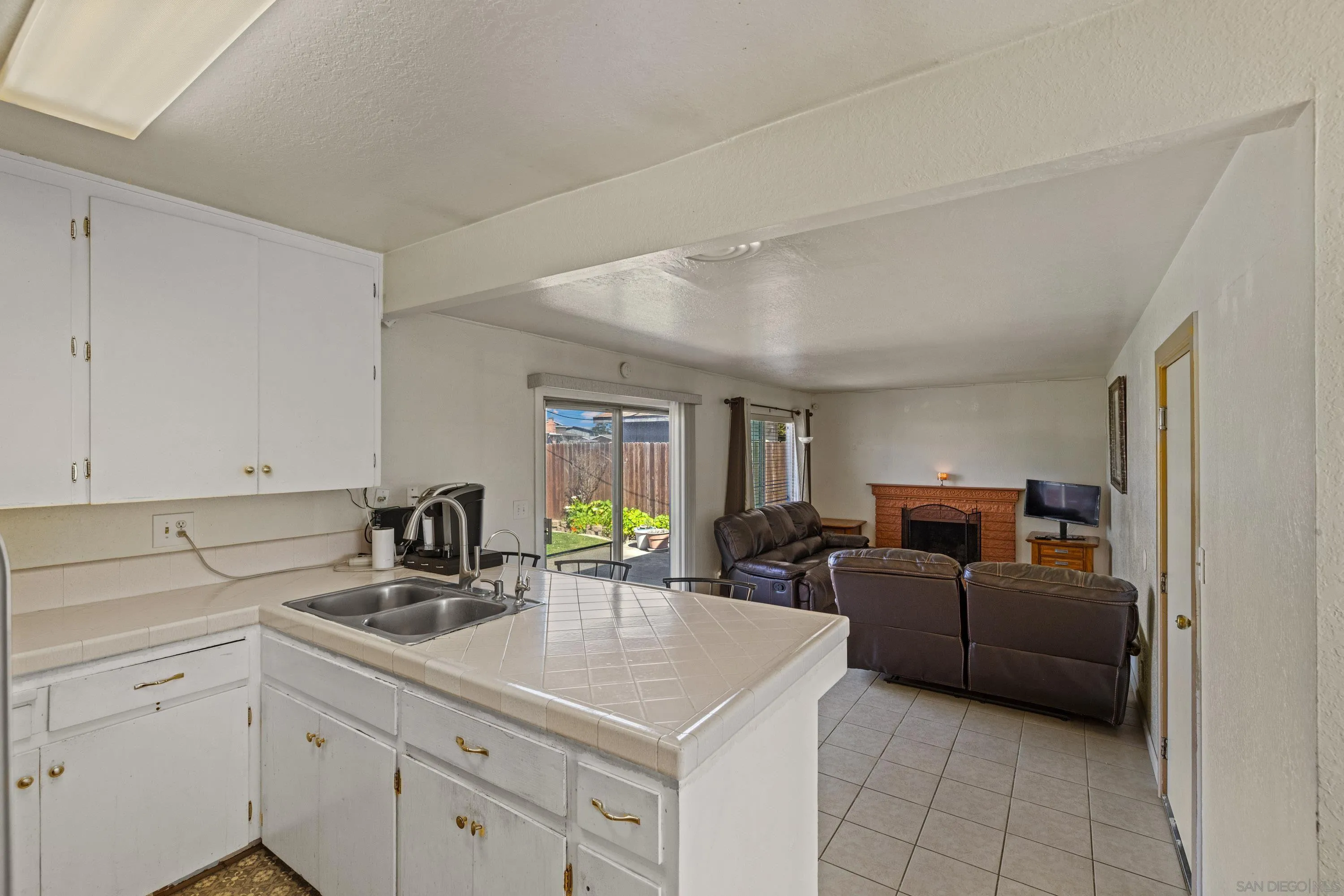 284 Osage Drive Salinas, CA 93906 - Photo 8 of 24 a kitchen with a sink dishwasher a stove and white cabinets with wooden floor