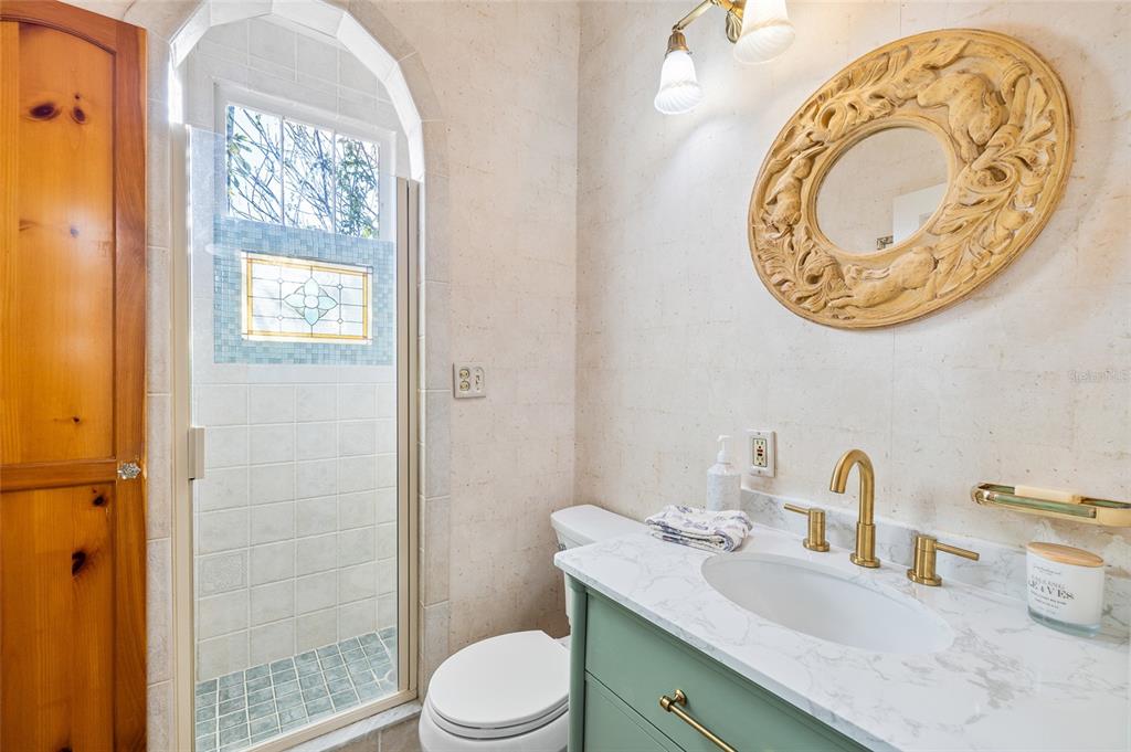 212 South Coolidge Avenue Tampa, FL 33609 - Photo 6 of 6 a bathroom with a granite countertop sink mirror vanity and toilet
