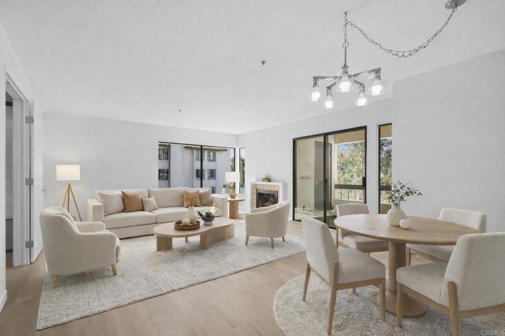 a living room with furniture a chandelier and a dining room