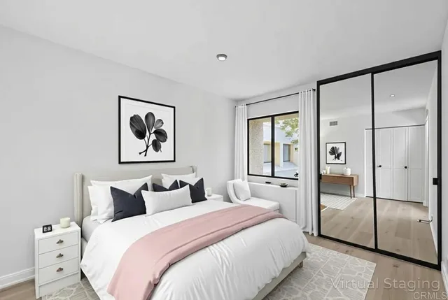 a bedroom with a large bed and glass door