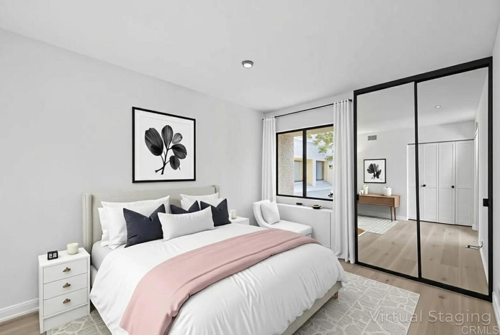 5745 Friars Road, Unit 116 San Diego, CA 92110 - Photo 12 of 44 a bedroom with a large bed and glass door