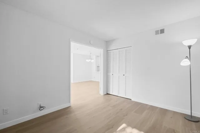 a view of an empty room and wooden floor