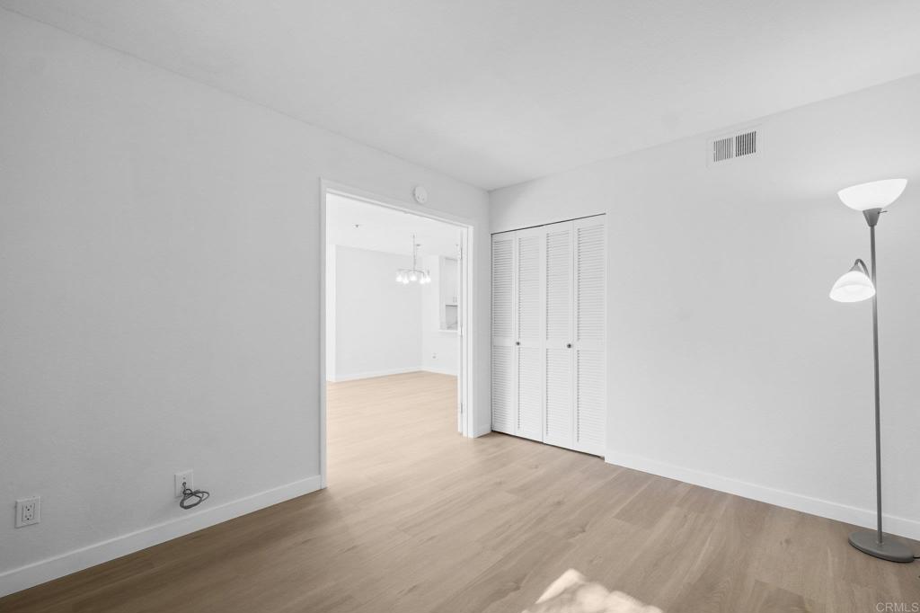 5745 Friars Road, Unit 116 San Diego, CA 92110 - Photo 14 of 44 a view of an empty room and wooden floor
