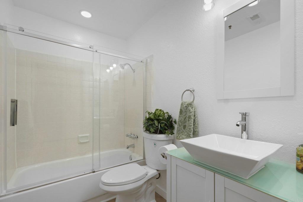 5745 Friars Road, Unit 116 San Diego, CA 92110 - Photo 15 of 44 a bathroom with a sink a toilet and shower