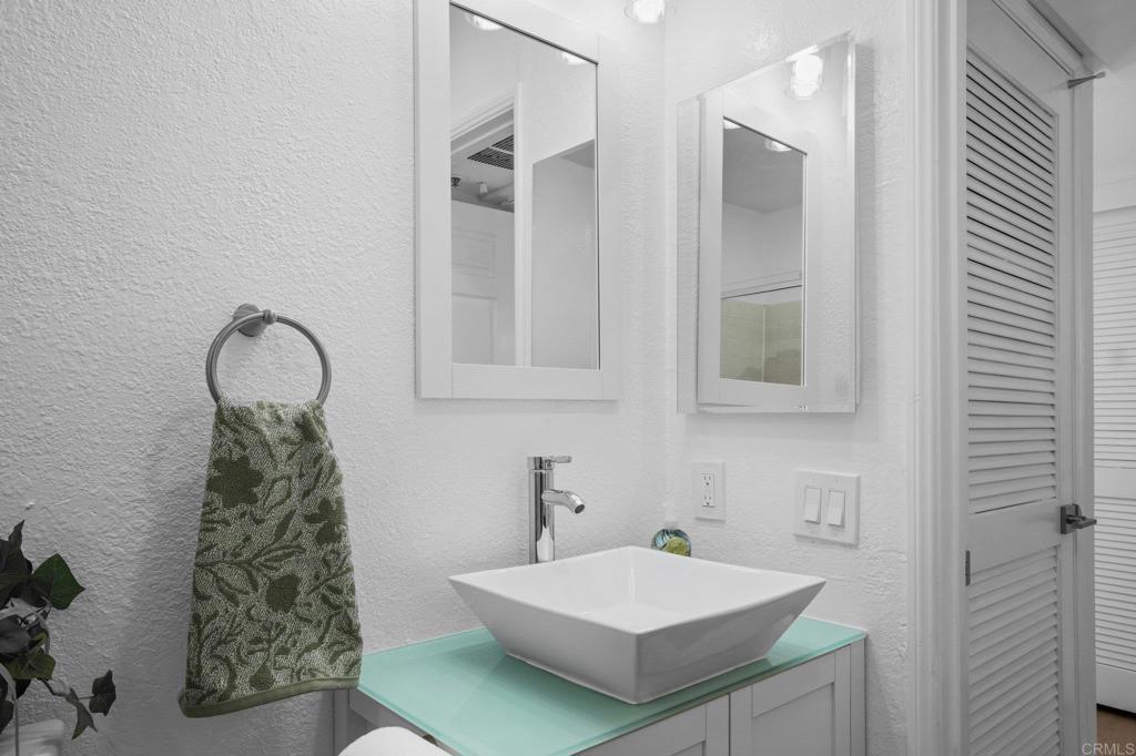5745 Friars Road, Unit 116 San Diego, CA 92110 - Photo 16 of 44 a bathroom with a sink and a mirror