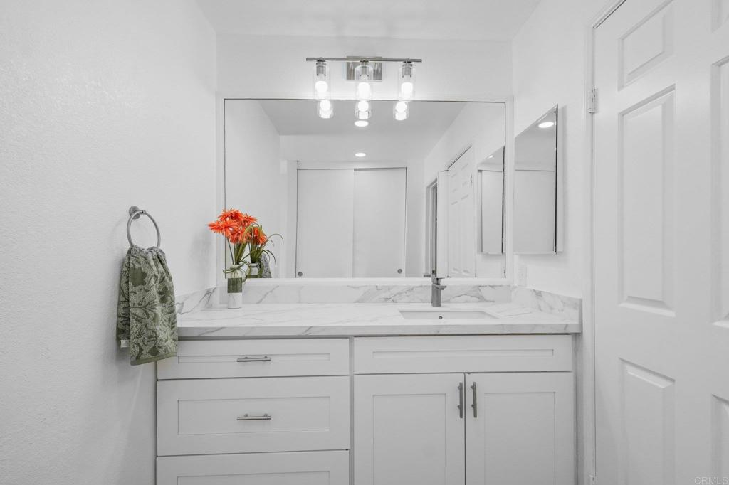 5745 Friars Road, Unit 116 San Diego, CA 92110 - Photo 22 of 44 a bathroom with a sink vanity and a mirror
