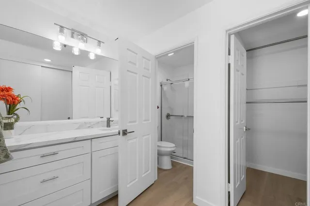 a bathroom with a double vanity sink a mirror and a shower