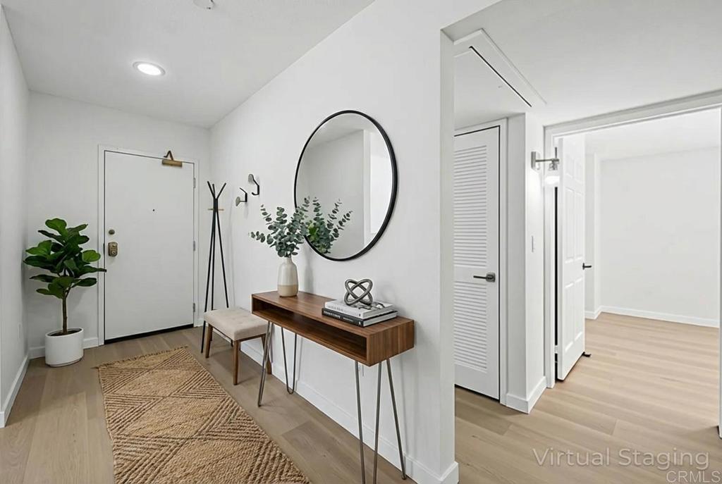 5745 Friars Road, Unit 116 San Diego, CA 92110 - Photo 3 of 44 a living room with furniture a mirror and a potted plant