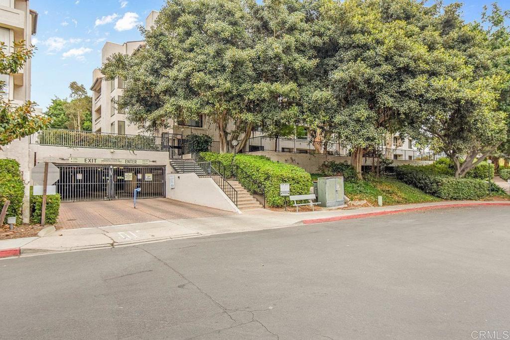 5745 Friars Road, Unit 116 San Diego, CA 92110 - Photo 35 of 44 a view of a patio with a table and chairs under an umbrella
