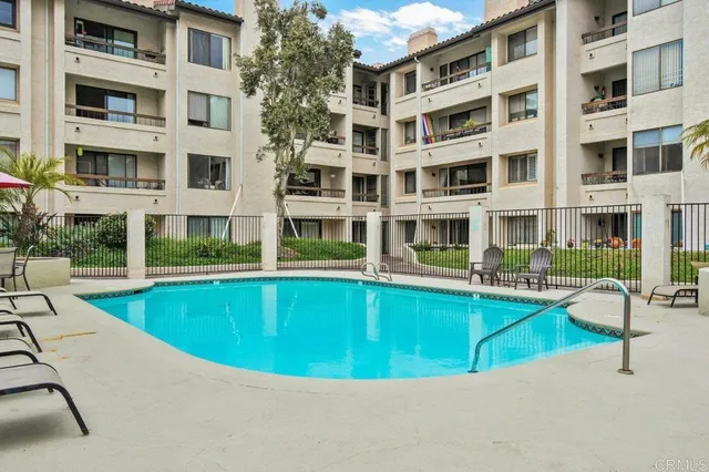 a view of yard with swimming pool and sitting area