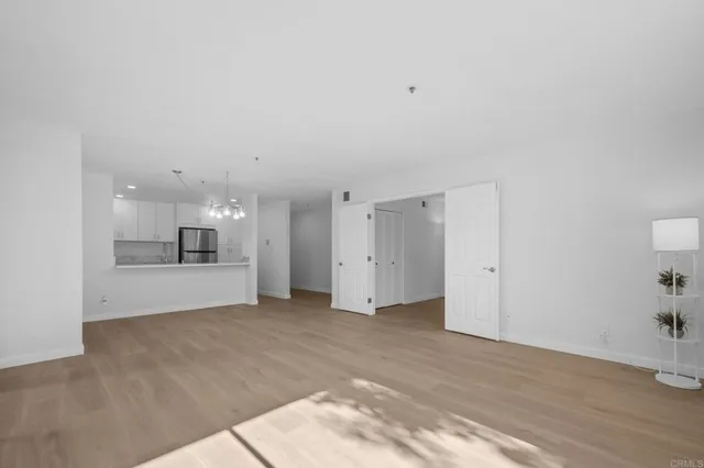 a view of a kitchen with a sink and a refrigerator