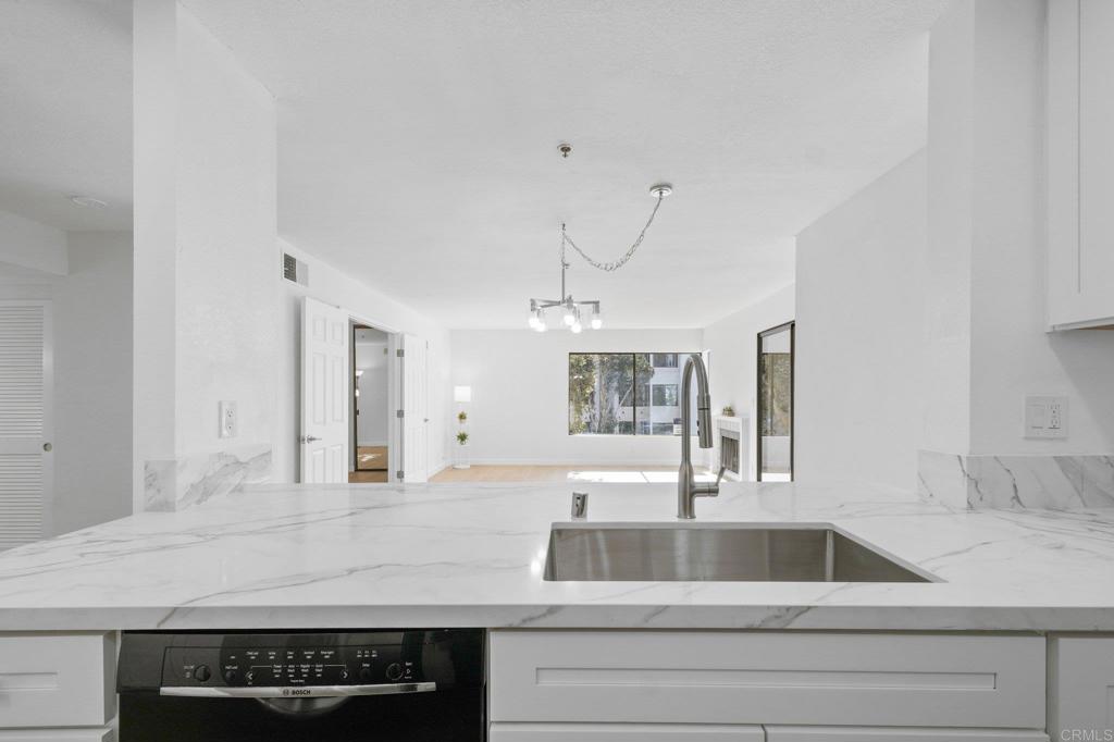 5745 Friars Road, Unit 116 San Diego, CA 92110 - Photo 8 of 44 a kitchen with a sink and a refrigerator