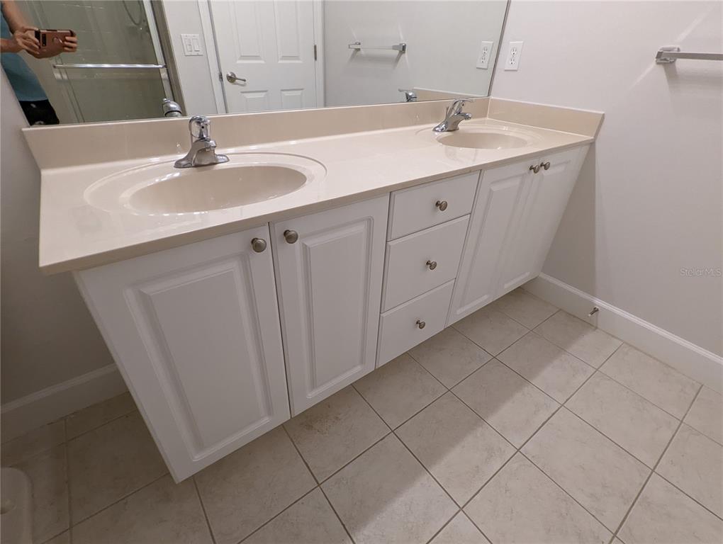 7782 Southwest 64th Lane, Unit 1002 Gainesville, FL 32608 - Photo 19 of 42 a bathroom with a sink and a mirror