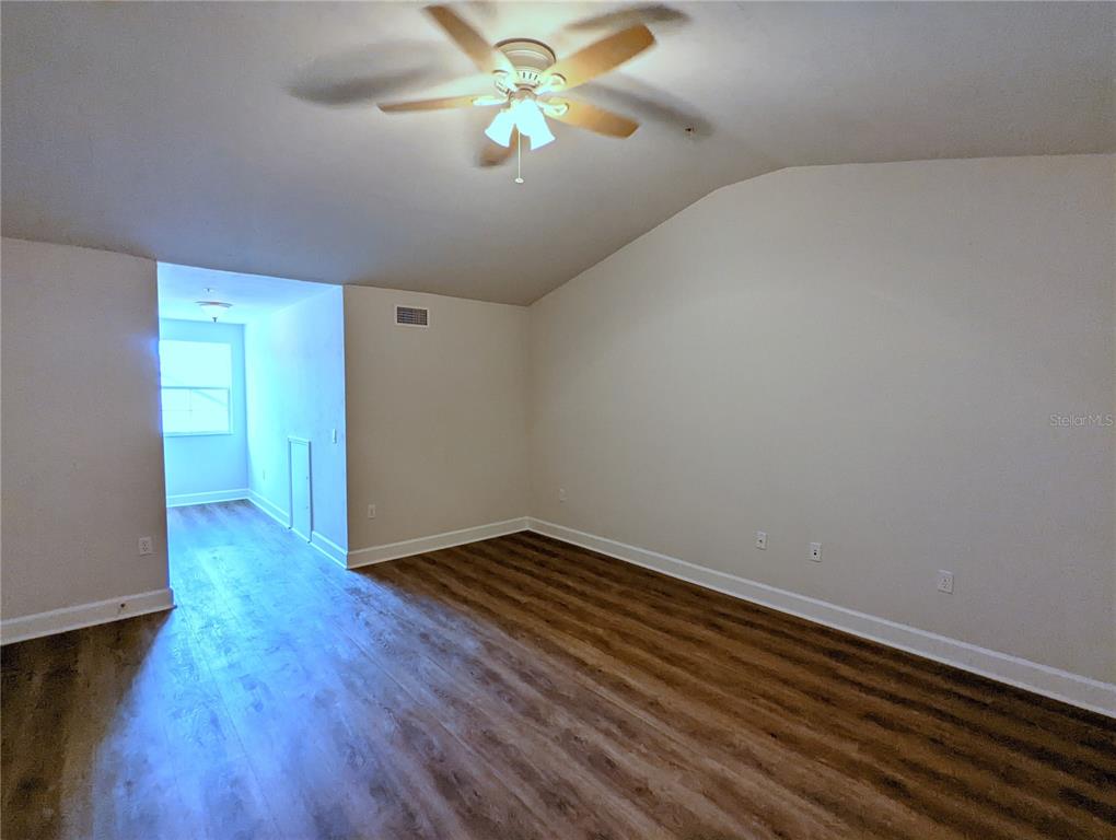 7782 Southwest 64th Lane, Unit 1002 Gainesville, FL 32608 - Photo 29 of 42 a view of an empty room with window and wooden floor