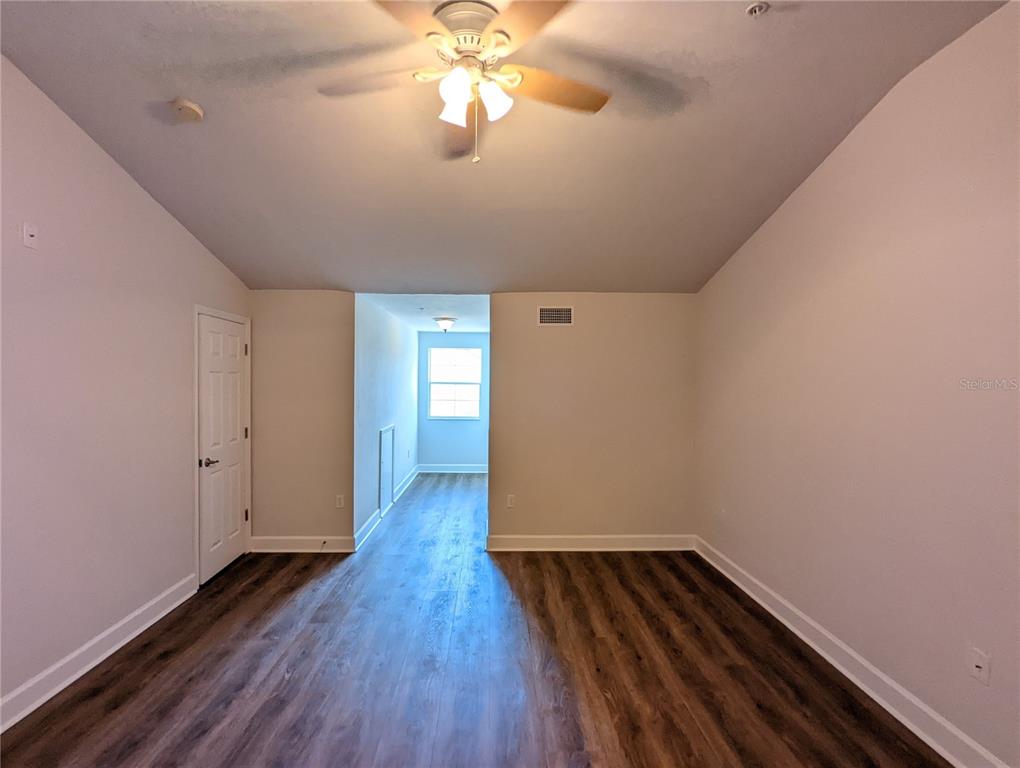 7782 Southwest 64th Lane, Unit 1002 Gainesville, FL 32608 - Photo 30 of 42 a view of an empty room with wooden floor