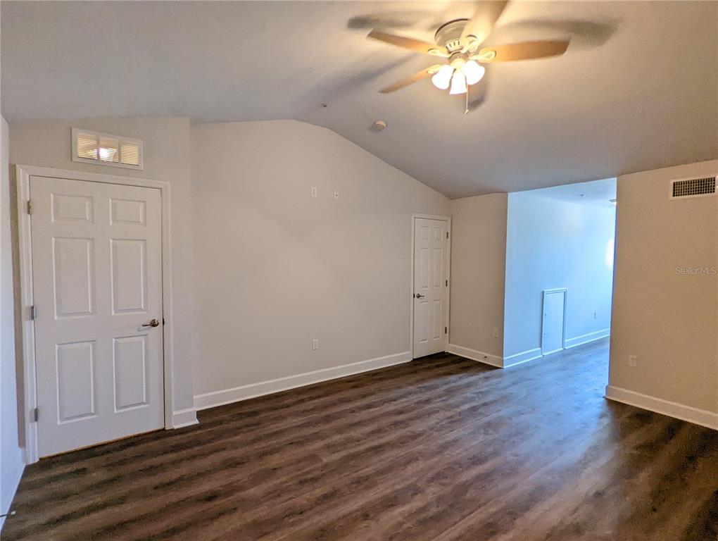 7782 Southwest 64th Lane, Unit 1002 Gainesville, FL 32608 - Photo 31 of 42 a view of an empty room with a window and wooden floor