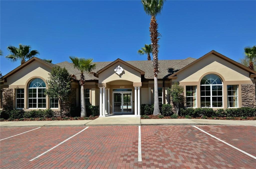 7782 Southwest 64th Lane, Unit 1002 Gainesville, FL 32608 - Photo 34 of 42 a view of a brick house with a large windows and a yard
