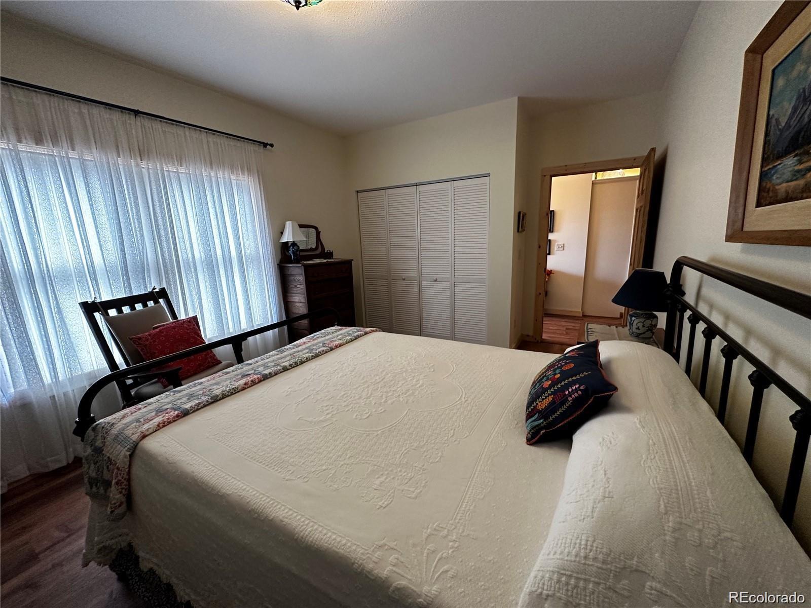 406-449 Schierl Road Fort Garland, CO 81133 - Photo 26 of 50 a bedroom with a bed and wooden floor