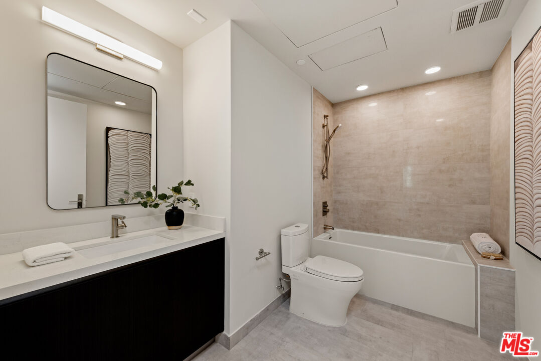 505 South Barrington Avenue, Unit 303 Los Angeles, CA 90049 - Photo 14 of 41 a bathroom with a sink a toilet and shower