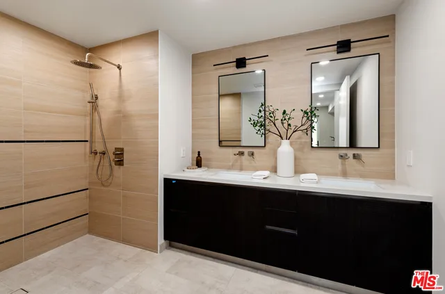 a bathroom with a double vanity sink and mirror