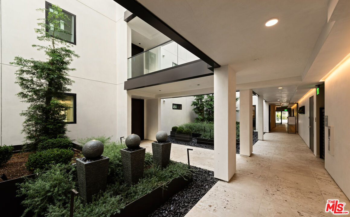 505 South Barrington Avenue, Unit 303 Los Angeles, CA 90049 - Photo 22 of 41 a front view of a house with a porch