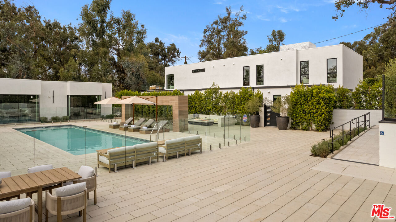 505 South Barrington Avenue, Unit 303 Los Angeles, CA 90049 - Photo 24 of 41 a view of a house with swimming pool and sitting area
